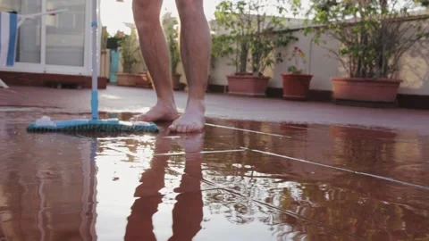 Caucasian man mopping a tile in the yard with a wet mop Stock Footage 147173750