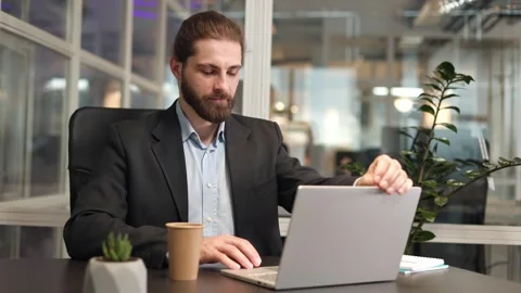 Caucasian man opening modern portable computer and start work at office Stock Footage 257528632
