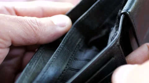 Caucasian man opens hes empty black synthetic leather wallet Stock Footage 205018908