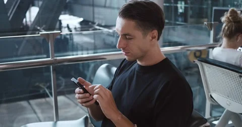 Caucasian Man passenger using smartphone in airport terminal for online check-in Stock Footage 251698227