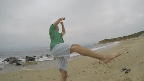 Caucasian Man Performs Corkscrew Flip at Beach, Tricking Slow Motion Stock Footage 146552826