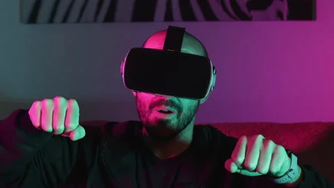 Caucasian man playing a game in virtual augmented reality Metaverse. Excited man Stock Footage 165685517