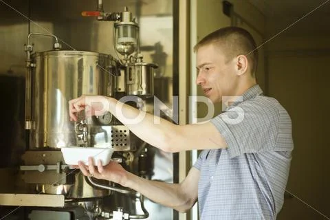 Caucasian Man Pouring Hot Water Into Bowl