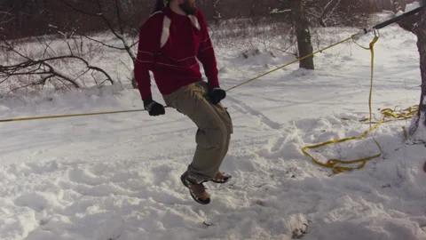 Caucasian man practicing slackline in the winter forest. 스톡 동영상 147160739