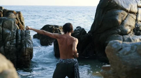 Caucasian man practicing  tai chi inside pacific ocean waves Stock Footage 61955554