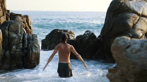Caucasian man practicing  tai chi inside pacific ocean waves Stock Footage 61955614