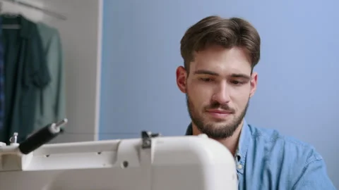 Caucasian man preparing sewing machine at home by himself 스톡 동영상 244800645