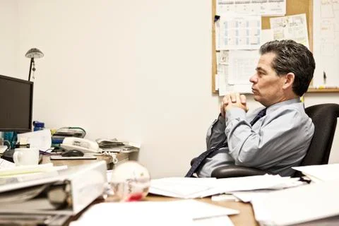 Caucasian man problem solving at his office desk. Foto stock