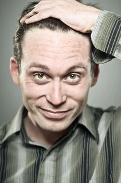 Caucasian Man Pulling Back His Hair Stock Photos
