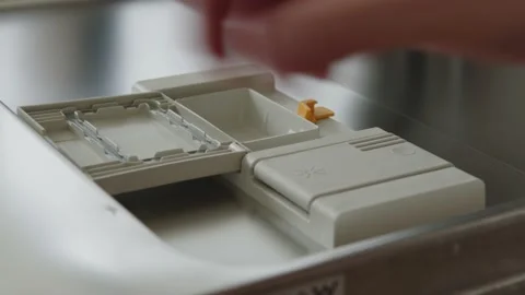 Caucasian Man Puts Detergent Tablet in Dishwasher Dispenser. Close Up Stock Footage 168721307