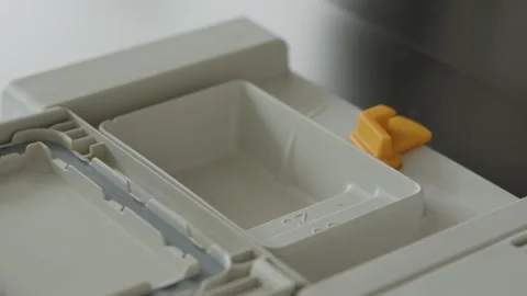Caucasian Man Puts Detergent Tablet in Dishwasher Dispenser. ECU Stock Footage 168721328
