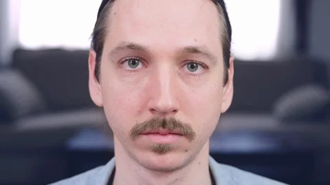 A caucasian man puts on a protective face mask - Close Up - slow motion Stock Footage 128834532