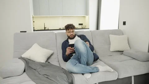 Caucasian man reading book alone at home Stock Footage 333981983