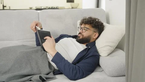 Caucasian man reading book alone at home Stock-Footage 333982029