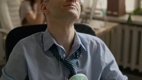 Caucasian Man Resting in Computer Char, Breaking into Smile Stock-Footage 335459532
