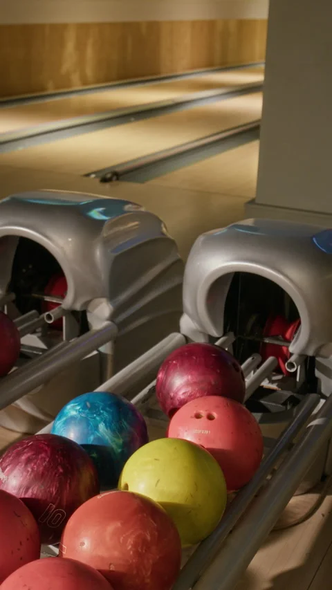 Caucasian Man Selecting Bowling Ball from Return Machine Stock Footage 337096929