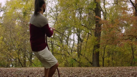 Caucasian man sets slackline between trees in the autumn forest. 스톡 동영상 142131433