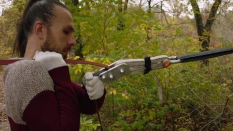 Caucasian man sets slackline between trees in the autumn forest. 스톡 동영상 142271508