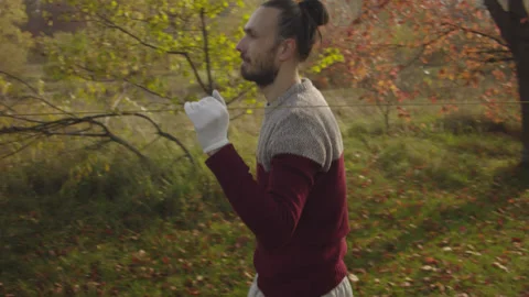 Caucasian man sets slackline between trees in the autumn forest. Stock-Footage 142304943