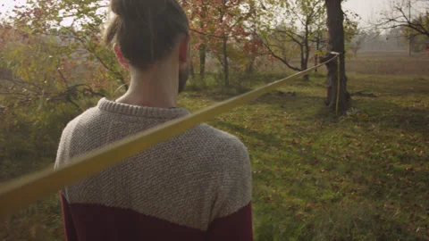 Caucasian man sets slackline between trees in the autumn forest. Stock-Footage 142312575
