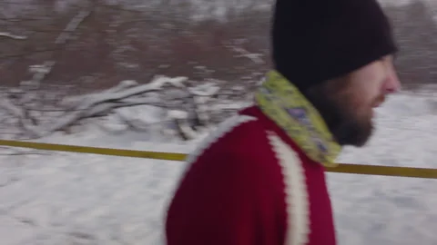 Caucasian man sets slackline between trees in the winter forest. 스톡 동영상 146963341
