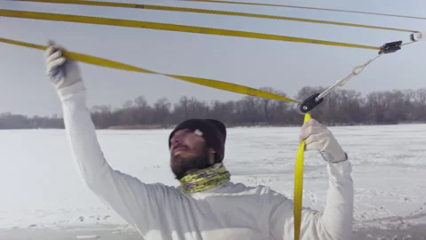 Caucasian man sets slackline between trees in the winter forest. Stock Footage 148165506