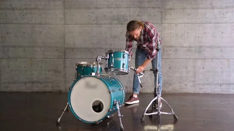 Caucasian Man is Setting Up A Drum Set  before Playing - Drum Lesson. Stock Footage 155554953