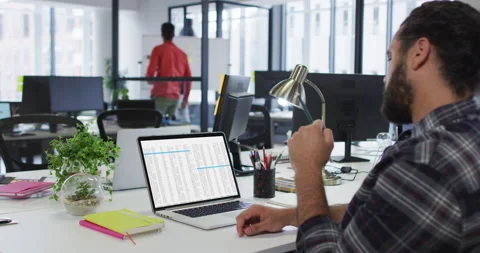 Caucasian man sitting at desk watching coding data processing on laptop screen Stock Footage 160056417