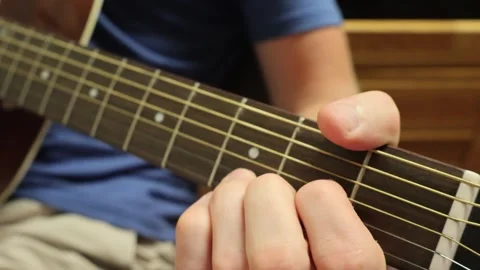 Caucasian man sitting down playing guitar in open tuning Stock Footage 279909185