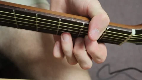 Caucasian man sitting down playing guitar in the open tuning Stock Footage 279909207