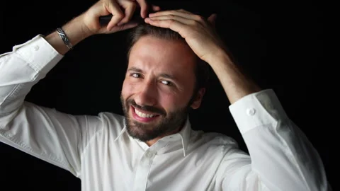Caucasian man smiling while combing his hair Stock Footage 285090422