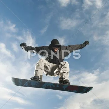 Caucasian Man On Snowboard In Mid-Air