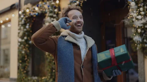 Caucasian man standing dancing on the decorated street listening to music Video stock 220076476