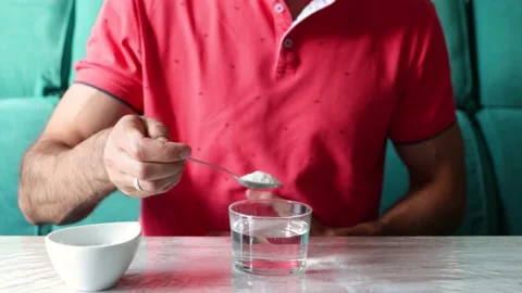 Caucasian man with stomach ache preparing fizzy fruit salt in a glass of wate Stock Footage 219722158
