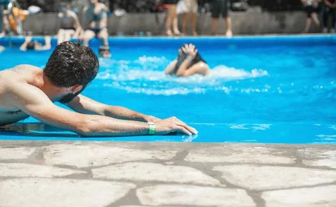 Caucasian man in the swimming pool. Stock Photos