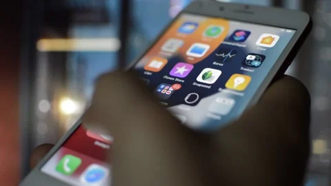 Caucasian man swipe iphone screen display in the night city blur background. Stock Footage 236378875