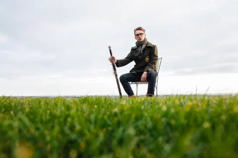 Caucasian man with sword in field Stock Photos