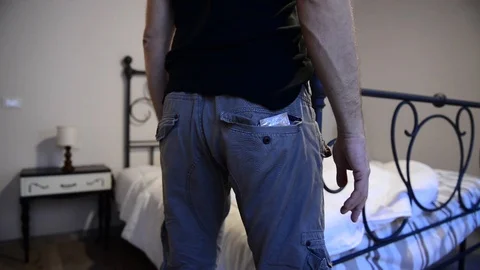 Caucasian man taking off his condom for a safe sex 스톡 동영상 122049853