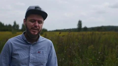 A Caucasian man is talking to the camera. The concept of blogging in nature. Stock Footage 298308511