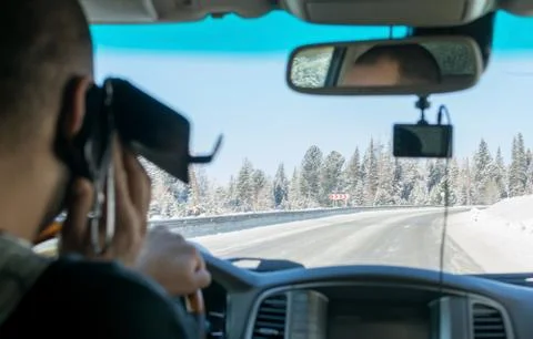 Caucasian man talking on the phone while driving a car Foto stock