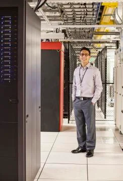Caucasian man technician working with computer servers in a computer server 스톡 사진