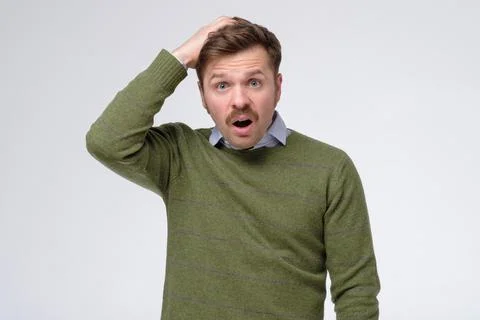 Caucasian man thinking trying to remember something, confused, looking for right Stock Photos