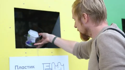 Caucasian man throws out plastic containers in a recycling bin Stock-Footage 234844286