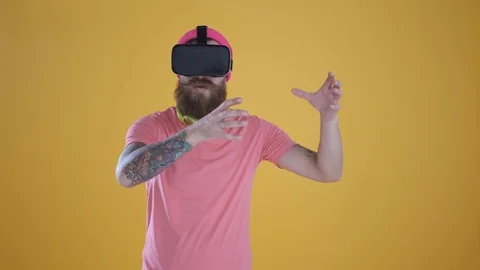Caucasian man touch something using modern 3D vr glasses ,yellow background Stock Footage 127622055