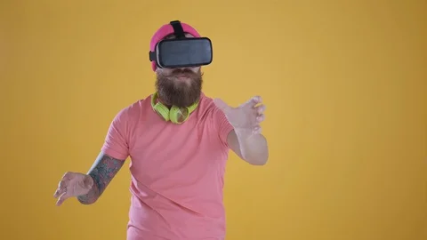 Caucasian man touch something using modern 3D vr glasses ,yellow background Stock Footage 127622167
