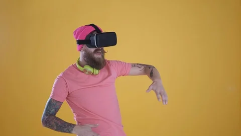 Caucasian man touch something using modern 3D vr glasses ,yellow background Stock Footage 127622544