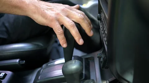 Caucasian man trying to operate a broken automatic transmission Stock Footage 313826093