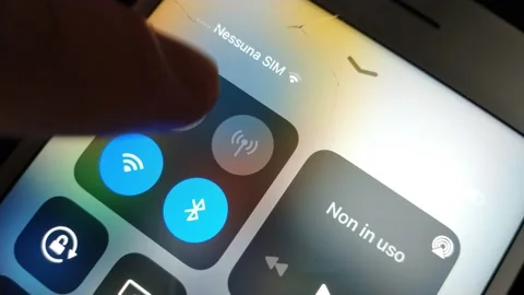 Caucasian man turn on flight mode icon on the iphone display. Stock Footage 234611345