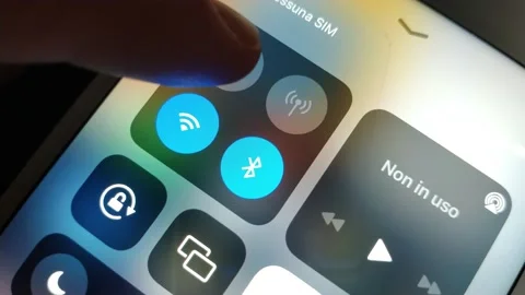 Caucasian man turn on flight mode icon on the iphone display. 스톡 동영상 234611706