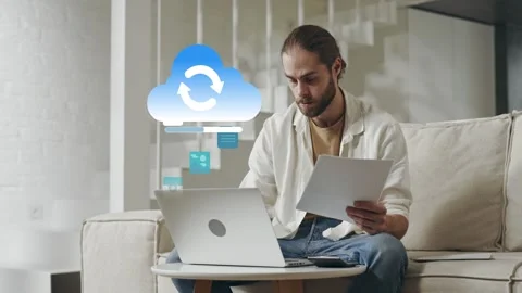 Caucasian man uploading data to cloud from living room Stock Footage 279342852